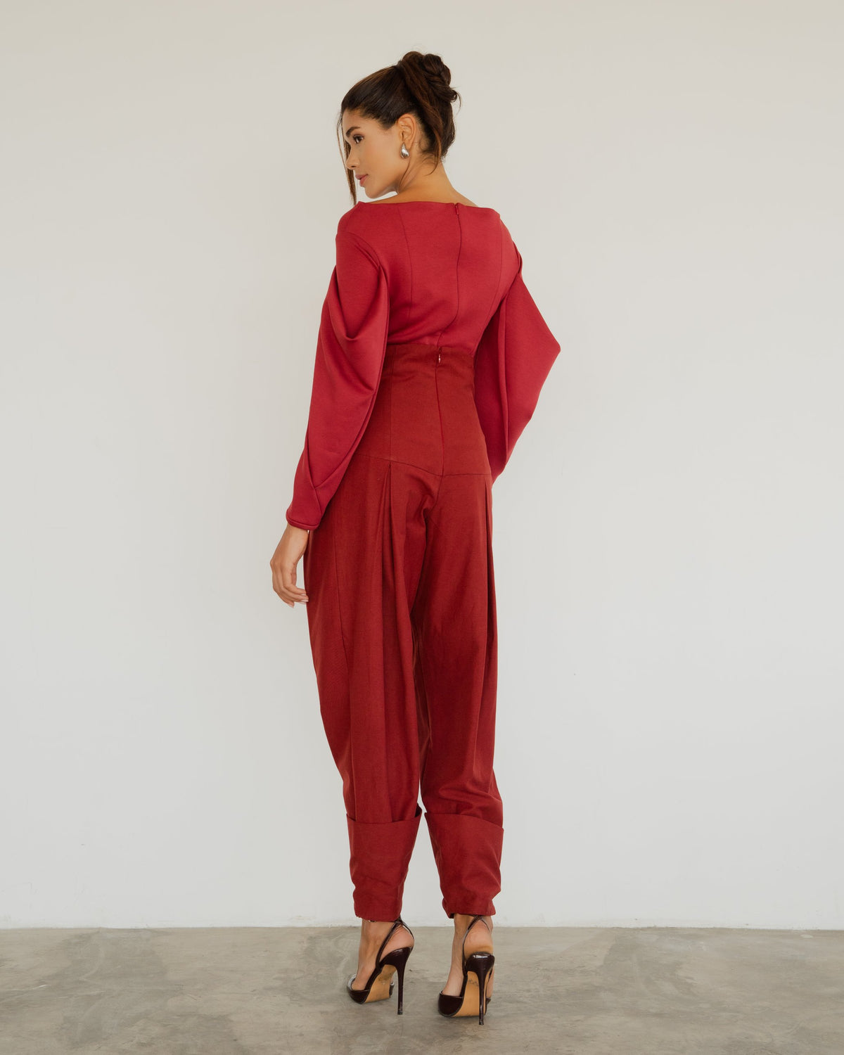 Model wearing the Andre Top in burgundy with the Nora Pants, back view