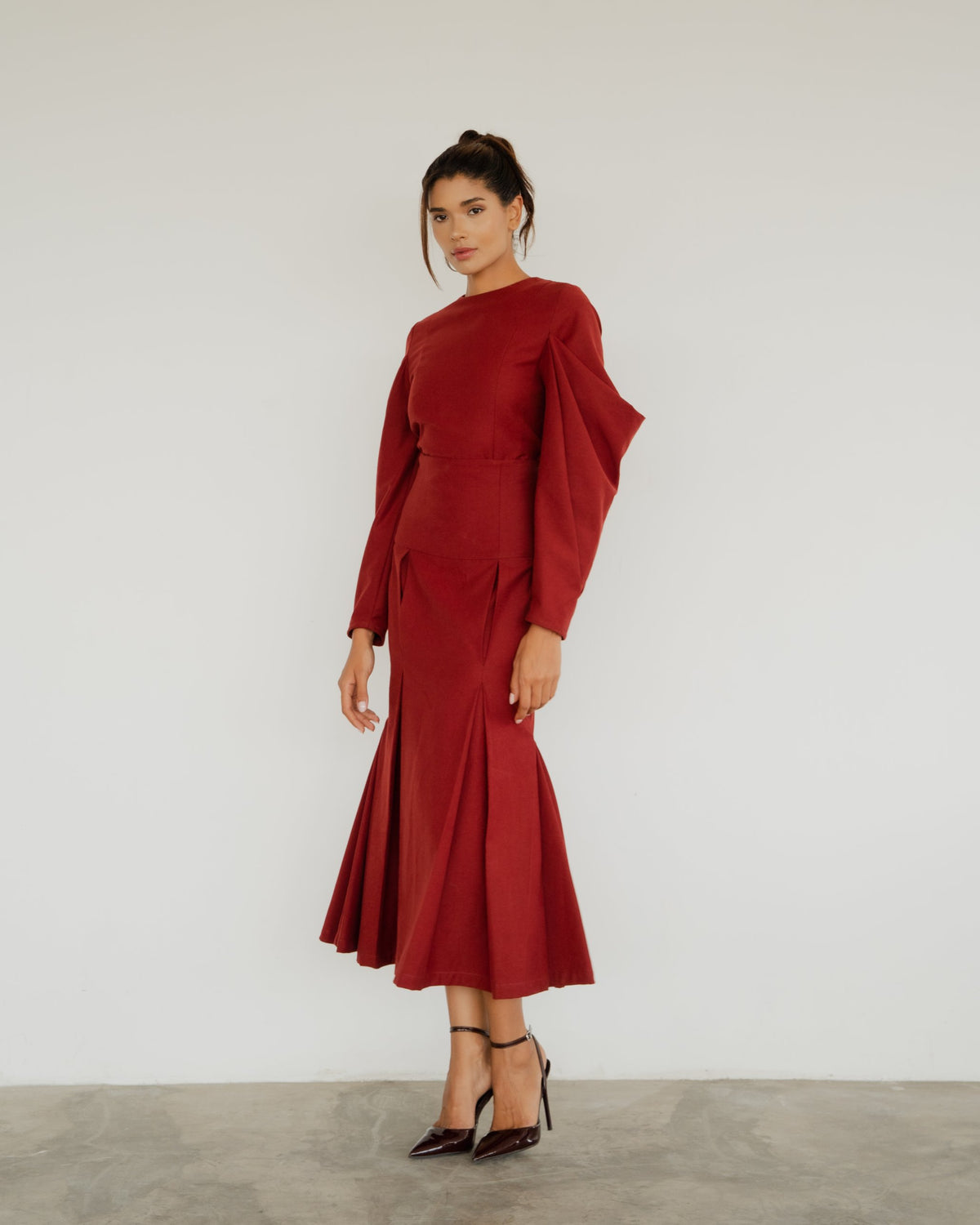 Model wearing the Anita Blouse in burgundy with the Neya Skirt, front view [Burgundy]