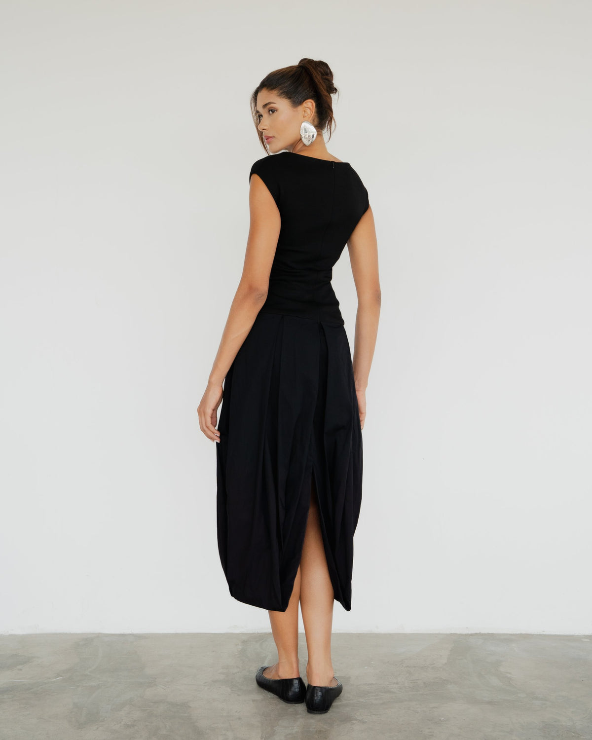 Model wearing the Lyon Dress in black, back view