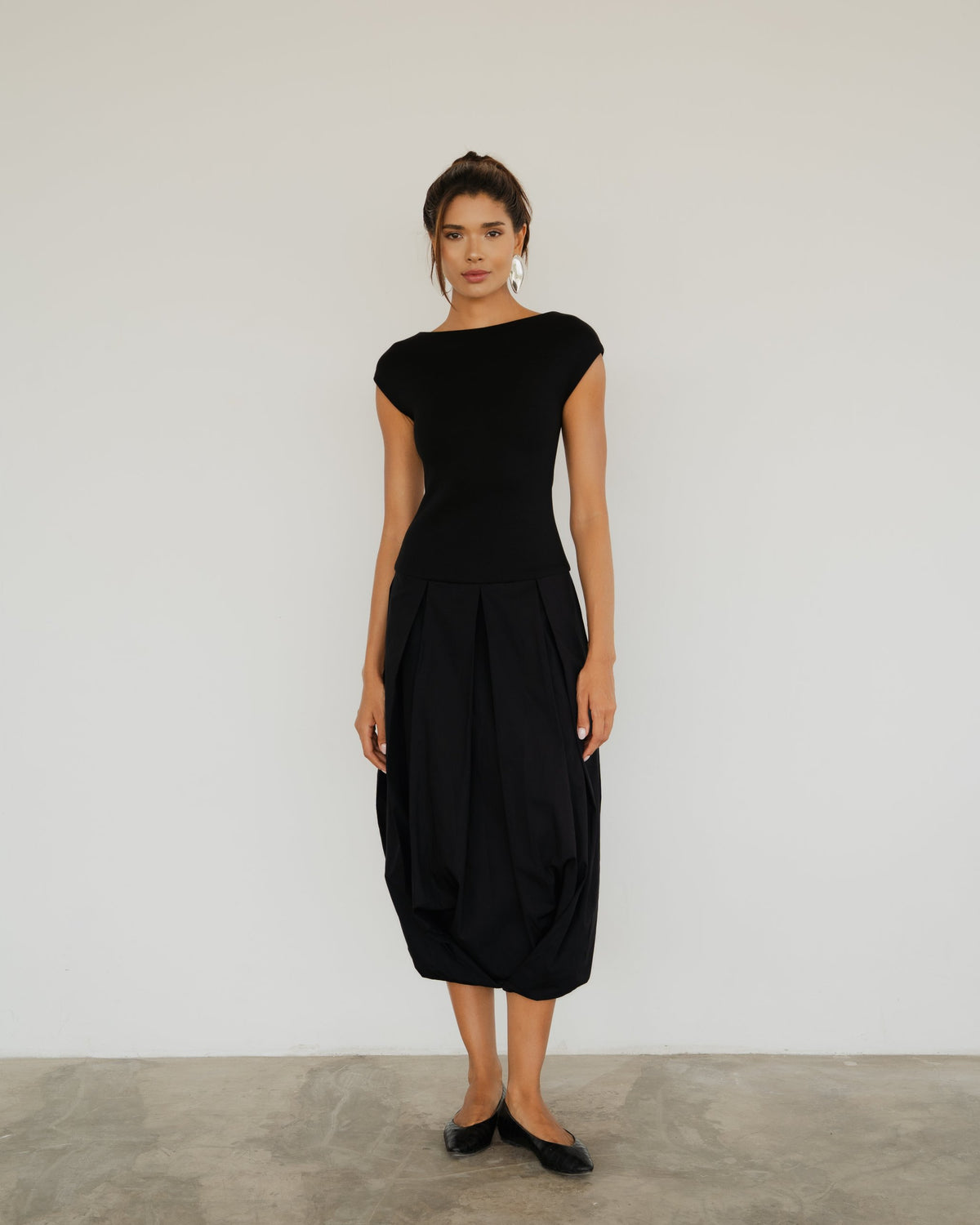 Model wearing the Lyon Dress in black, full-length front view