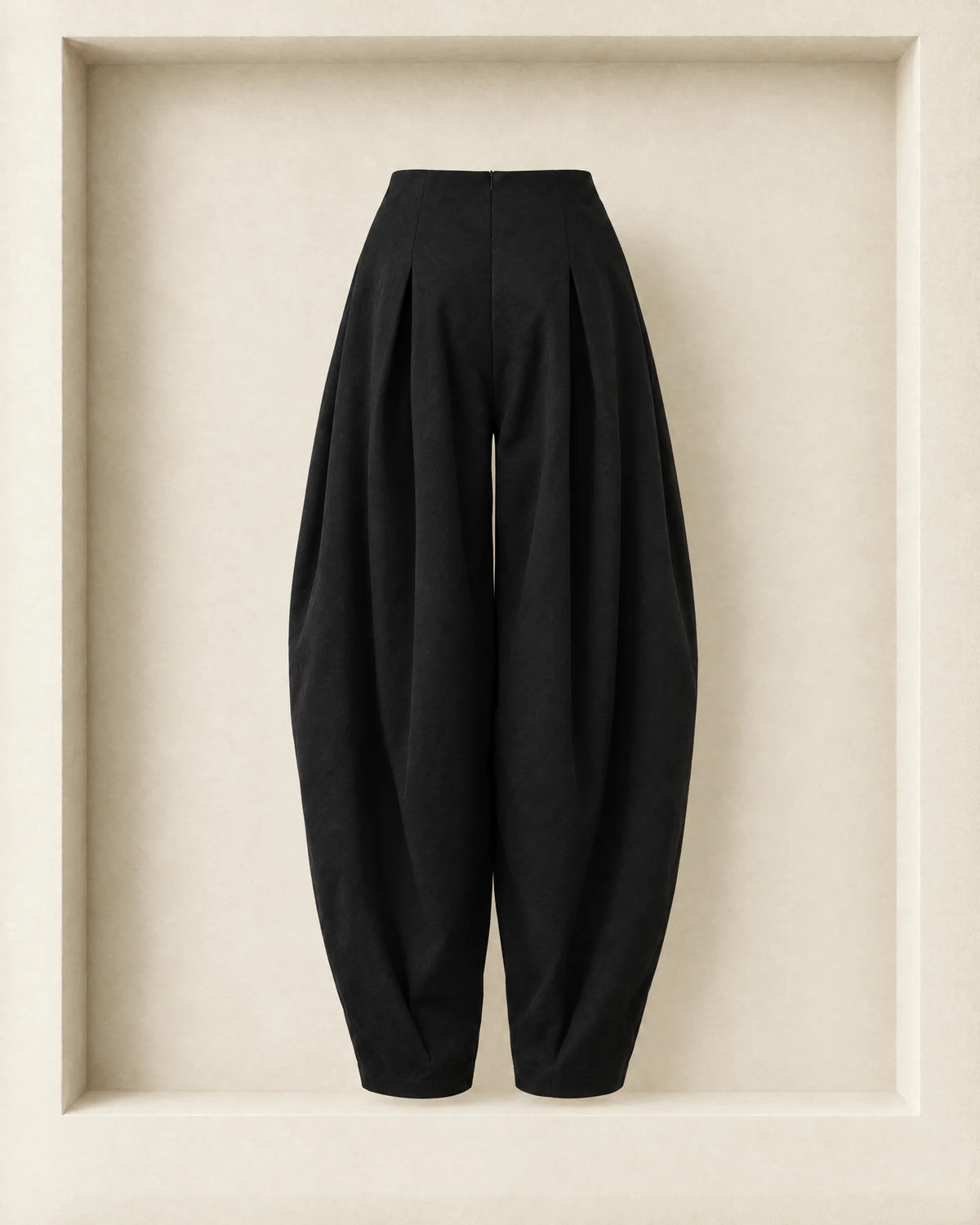 Nara Pants in black, back view — centre-back zip and rounded balloon leg