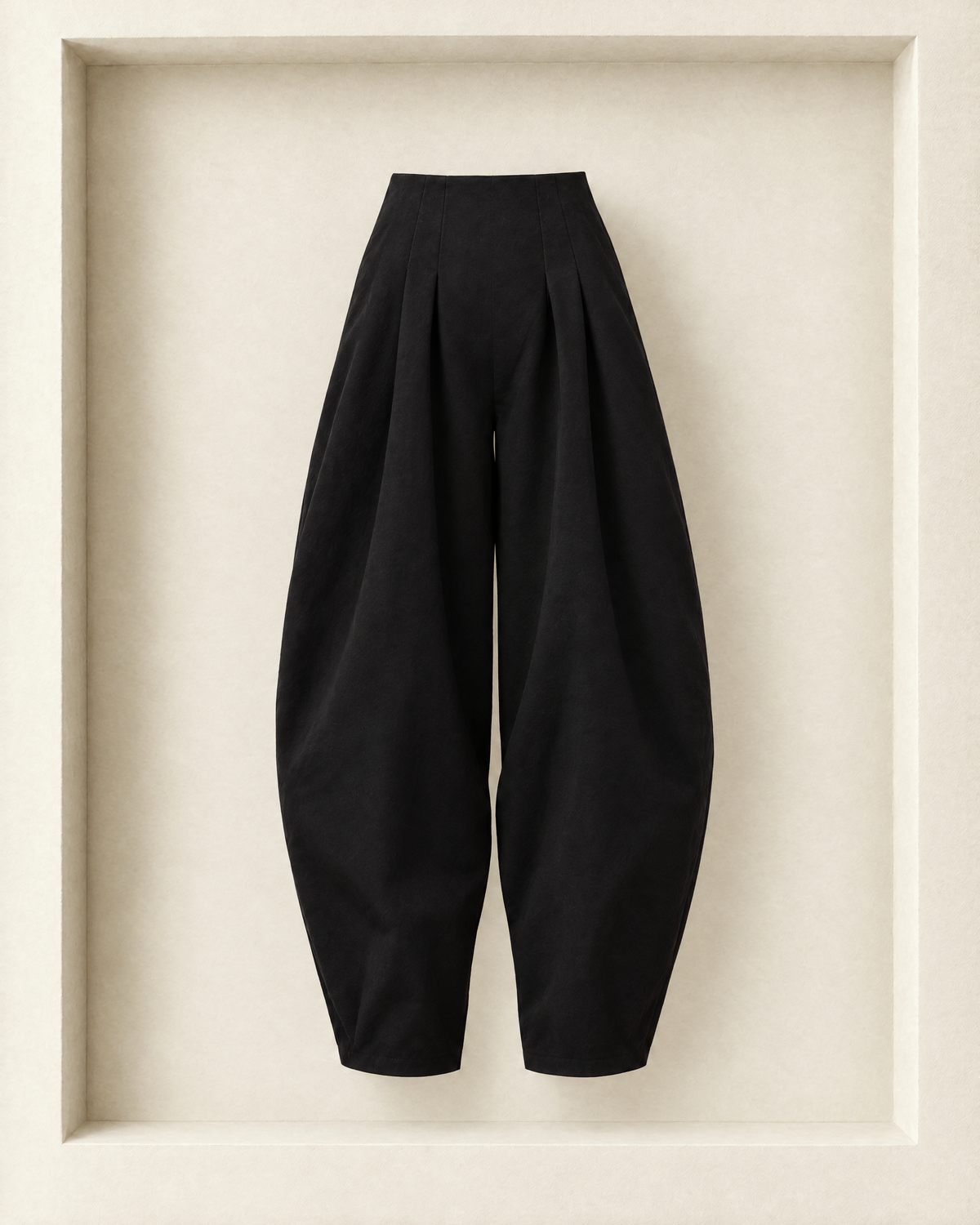Nara Pants in black, front view — waist pleats and full, rounded balloon leg