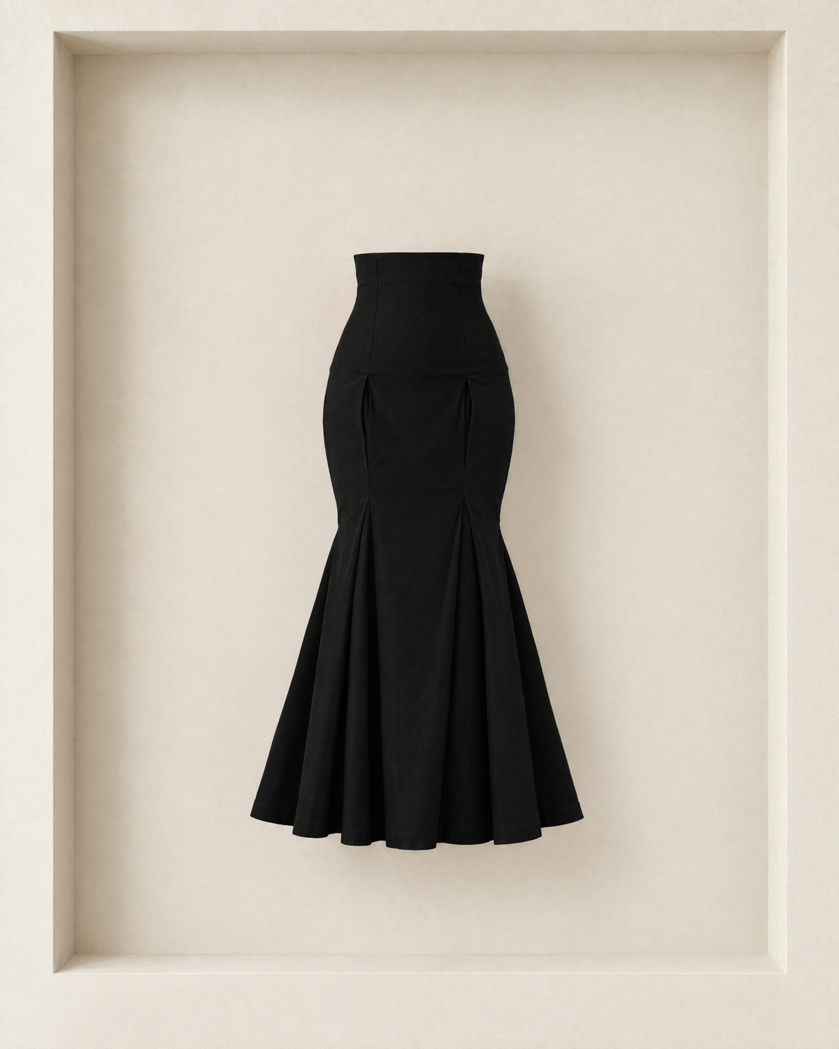 Neya Skirt in black, front view — high contoured yoke, hip pleats and pleated trumpet flare