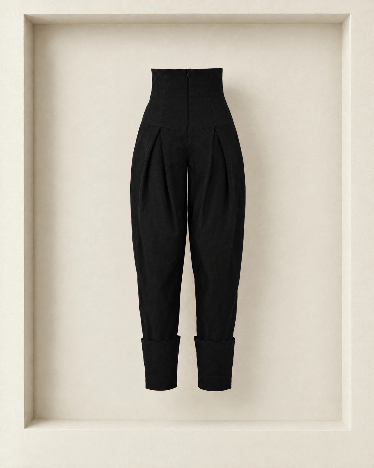 Nora Pants in black, back view — centre-back zip through the yoke and fold-up hems
